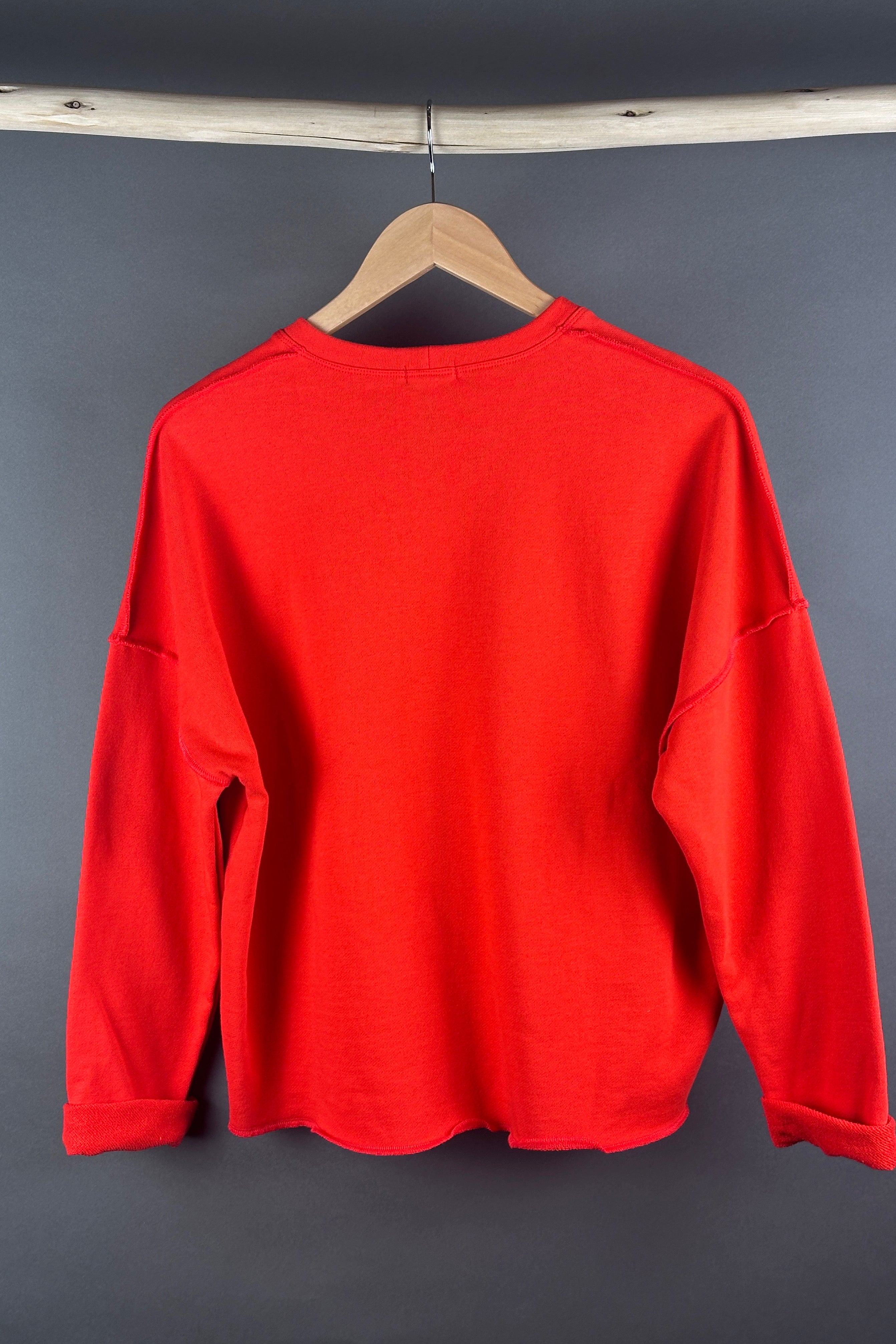 Tzusk loop back top in orange with crosses