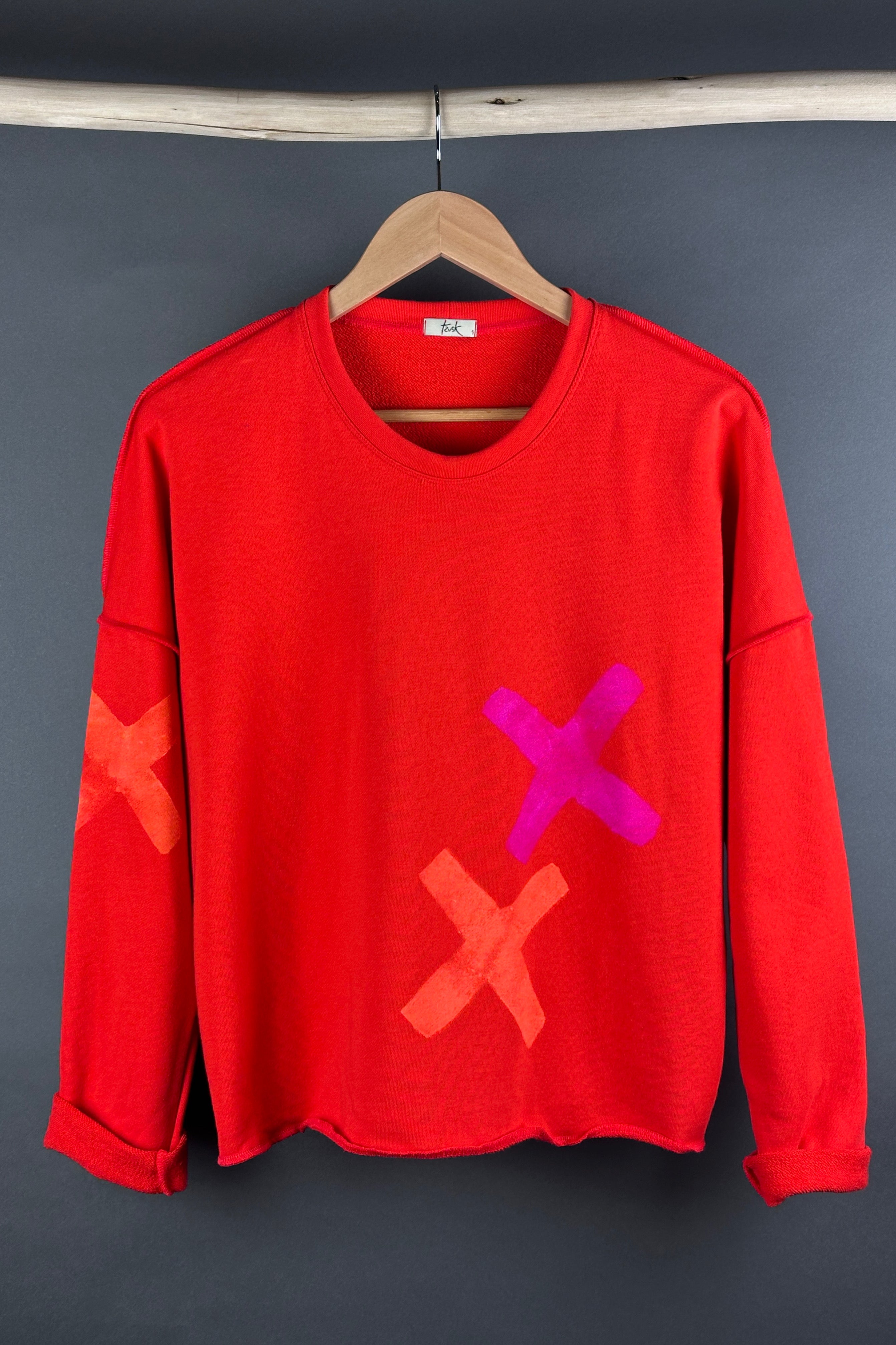 Tzusk loop back top in orange with crosses